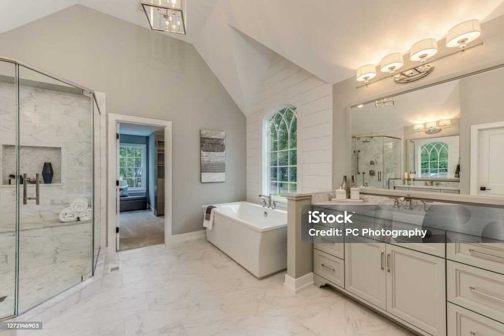 Soaking tub near a decorative window
